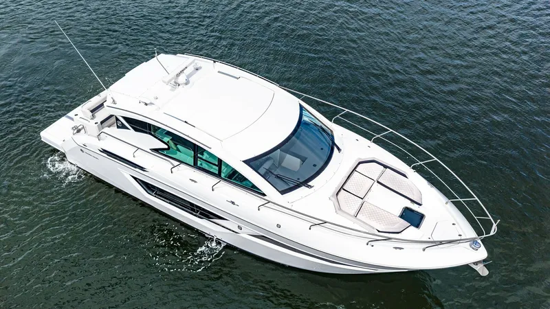 Slide: The Image of Aerial View of Bow and Cabin This image showcases the sleek and modern design of the 2019 Cantius 46 by Cruisers Yachts. The spacious bow area features plush sun pads for relaxation, while the elegantly curved cabin top enhances the vessel's aerodynamic profile. Large windows along t - 8141281