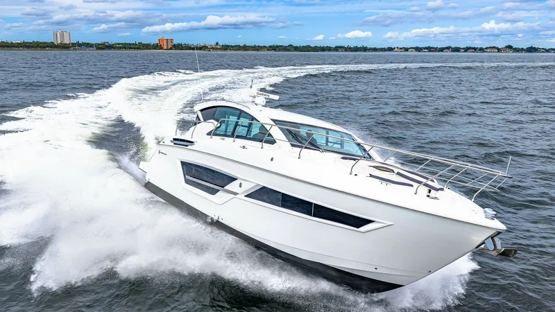 Slide: The Image of Dynamic Bow View in Motion The 2019 Cruisers Yachts Cantius 46, named Serenity, elegantly cuts through the water, showcasing its sleek and modern bow design. The vessel's aerodynamic lines and large windows offer a glimpse of the luxurious interior while ensuring ample natural ligh - 8141306
