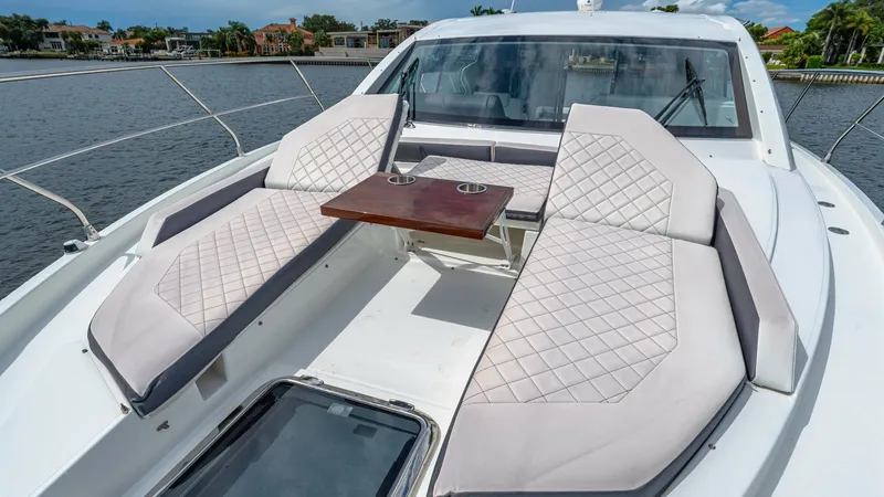 Slide: The Image of Spacious Bow Lounge with Seating The bow of the 2019 Cruisers Yachts Cantius 46 features a luxurious seating area with diamond-stitched upholstery and a central teak table, perfect for socializing or relaxing. The sleek design accentuates the modern aesthetic, while providing comfort and - 8141269