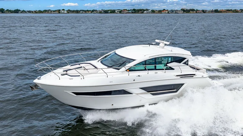 Slide: The Image of Dynamic Starboard Side View The 2019 Cruisers Yachts Cantius 46, named Serenity, glides effortlessly through the water, showcasing its sleek and modern design. The starboard side view highlights the elegant lines and expansive windows that flood the interior with natural light. Its - 8141304