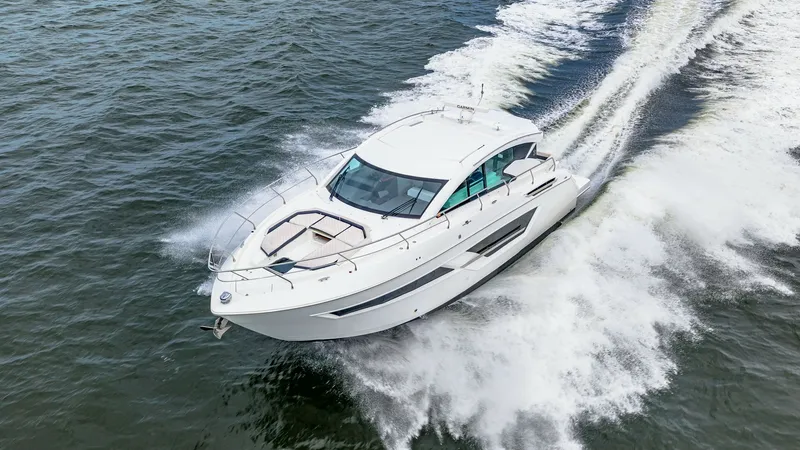 Slide: The Image of Aerial View of Cruisers Yachts Cantius 46 Captured in motion, the 2019 Cruisers Yachts Cantius 46 cuts through the water with elegance and power. The sleek design features a spacious foredeck with sun pads, perfect for lounging. Large windows and a streamlined profile enhance both the aesthetic a - 8141314