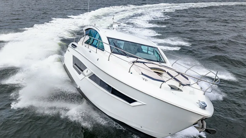 Slide: The Image of Dynamic Bow View in Motion The 2019 Cantius 46 by Cruisers Yachts showcases its sleek and modern design as it cuts through the water with ease. The aerodynamic profile and expansive windows offer both style and panoramic views, while the sturdy stainless steel railings ensure safet - 8141317