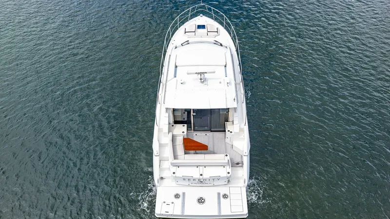 Slide: The Image of Aerial View of Aft Deck This aerial shot showcases the spacious aft deck of the 2019 Cruisers Yachts Cantius 46. The deck features comfortable seating and a sleek design, perfect for entertaining or relaxing. The open layout provides easy access to the water, making it ideal for - 8141301