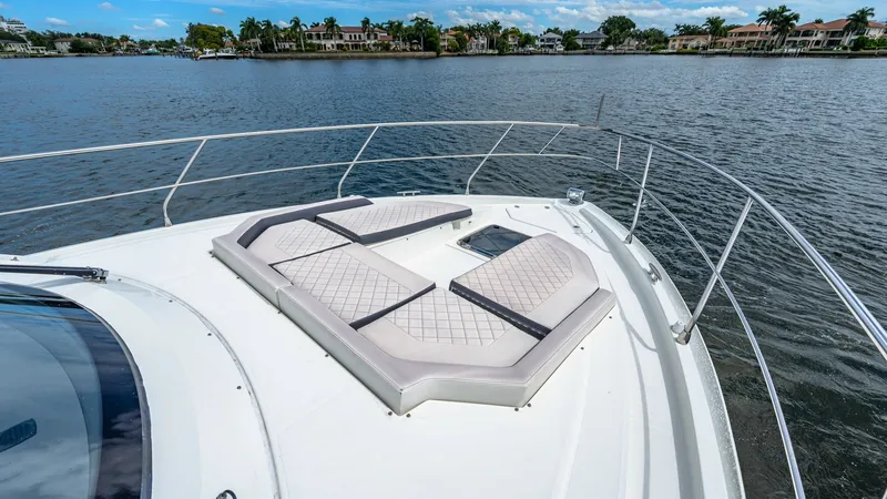 Slide: The Image of Spacious Bow Lounge Area The bow of the 2019 Cantius 46 by Cruisers Yachts features a luxurious lounge area with plush, diamond-stitched cushions for ultimate relaxation. Surrounded by sleek stainless-steel railing, this space offers panoramic views, making it perfect for sunbath - 8141271