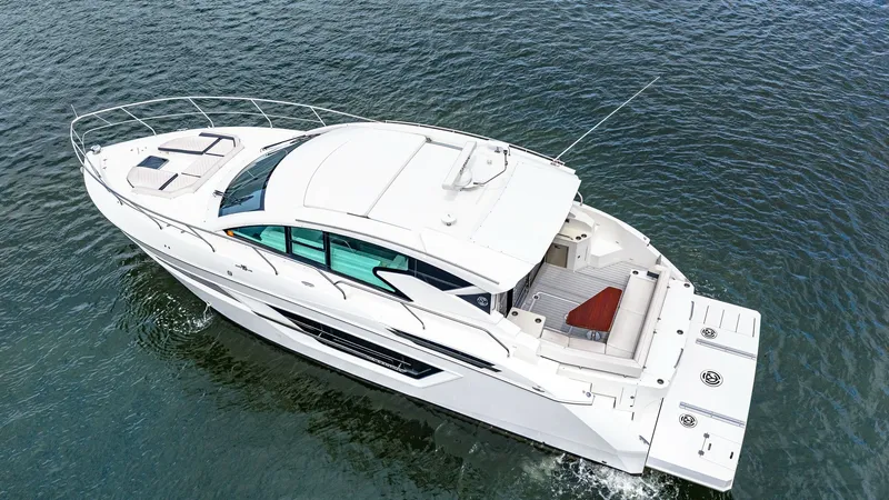 Slide: The Image of Aerial View of Aft Deck and Swim Platform This aerial shot highlights the spacious aft deck and swim platform of the 2019 Cantius 46 by Cruisers Yachts. The area features comfortable seating, perfect for relaxation or entertaining guests. The sleek design and modern lines of the vessel are comple - 8141300