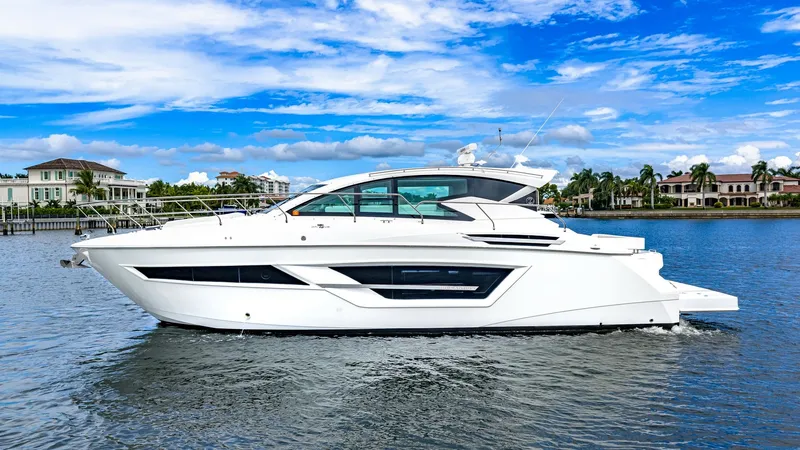 Slide: The Image of Starboard Side Profile View This image showcases the sleek starboard side profile of the 2019 Cruisers Yachts Cantius 46, named Serenity. The vessel's modern lines and expansive windows enhance its elegant aesthetic, while providing ample natural light to the interior spaces. The ae - 8141297
