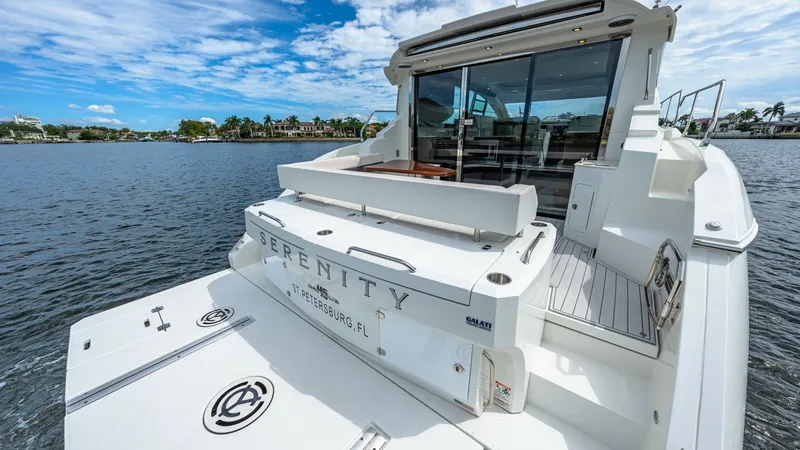 Slide: The Image of Spacious Aft Deck with Swim Platform The aft deck of the 2019 Cantius 46 'Serenity' features a generous swim platform, perfect for water activities and easy boarding. The sleek design extends into a comfortable seating area, ideal for socializing while enjoying the views. Glass doors provide - 8141258