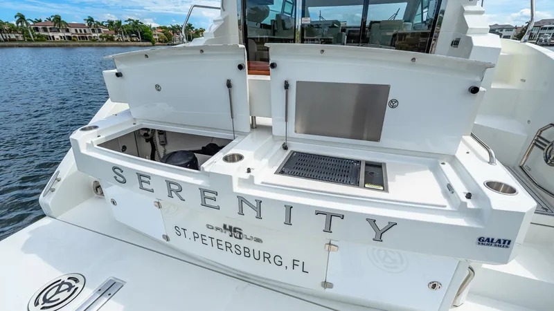 Slide: The Image of Aft Deck with Built-In Grill The aft deck of the 2019 Cantius 46, named Serenity, features a sleek built-in grill perfect for outdoor entertaining. The spacious area includes convenient storage compartments and a durable finish, ensuring functionality and style. The yacht's name and - 8141260
