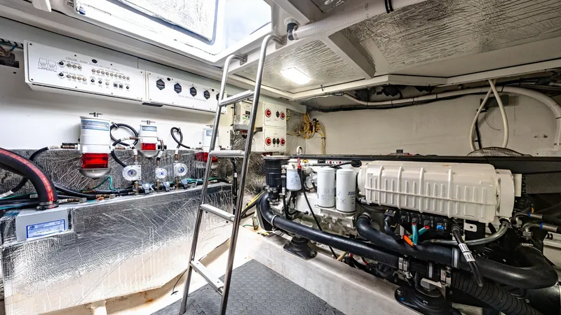 Slide: The Image of Engine Room with Mechanical Systems The engine room of the 2019 Cantius 46 by Cruisers Yachts showcases a well-organized layout with high-quality mechanical systems. The area features advanced control panels and filtration systems, ensuring efficient performance and easy maintenance. The am - 8141278