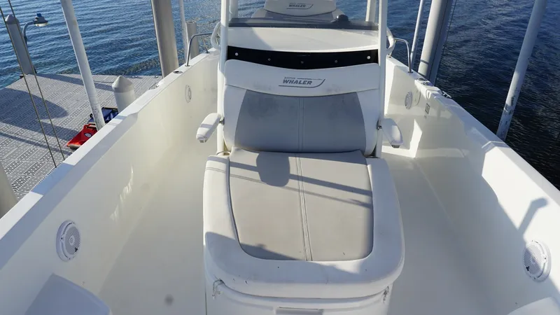 Slide: The Image of Forward Lounge Seating Area This image showcases the forward lounge seating area of the 2016 Boston Whaler 270 Dauntless. The cushioned seat offers comfort and relaxation, ideal for enjoying a day on the water. The clean, sleek design is complemented by durable materials, ensuring l - 8087572