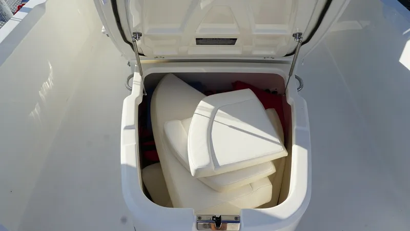 Slide: The Image of Spacious Bow Storage Compartment This image showcases the large bow storage compartment of the 2016 Boston Whaler 270 Dauntless. Designed for practicality, it provides ample space for storing cushions and essential gear. The compartment's robust build and secure latch ensure your items r - 8087574