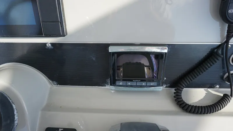 Slide: The Image of Helm Console with Electronics The helm console of the 2016 Boston Whaler 270 Dauntless features a modern electronic display and control panel. Key elements include a central screen for navigation and system monitoring, surrounded by intuitive controls for ease of operation. The layout - 8087568