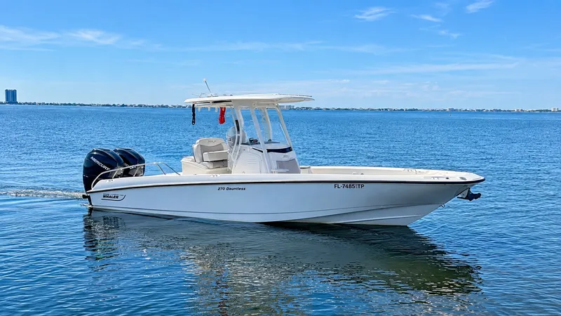 The Image of Side Profile of 2016 Boston Whaler 270 Dauntless This image captures the sleek side profile of the 2016 Boston Whaler 270 Dauntless, showcasing its elegant lines and robust build. The center console design is complemented by a spacious deck, perfect for fishing or leisure activities. Notable features in - 8087564