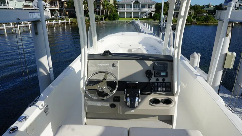 Slide: The Image of Boston Whaler 270 Dauntless Helm Station The helm station of the 2016 Boston Whaler 270 Dauntless offers a sleek and functional layout. Featuring a modern steering wheel and an array of navigational instruments, it ensures a smooth and controlled boating experience. The clean design and ergonomi - 8087570