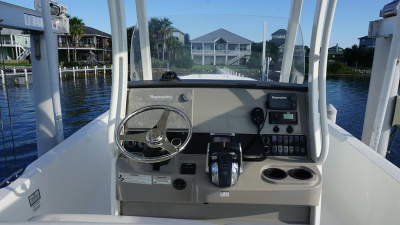 Slide: The Image of Helm Station with Electronics Display The helm station of the 2016 Boston Whaler 270 Dauntless features a sleek, user-friendly dashboard equipped with a Raymarine electronics display. The stainless-steel steering wheel and ergonomic throttle controls ensure a comfortable and efficient navigat - 8087571