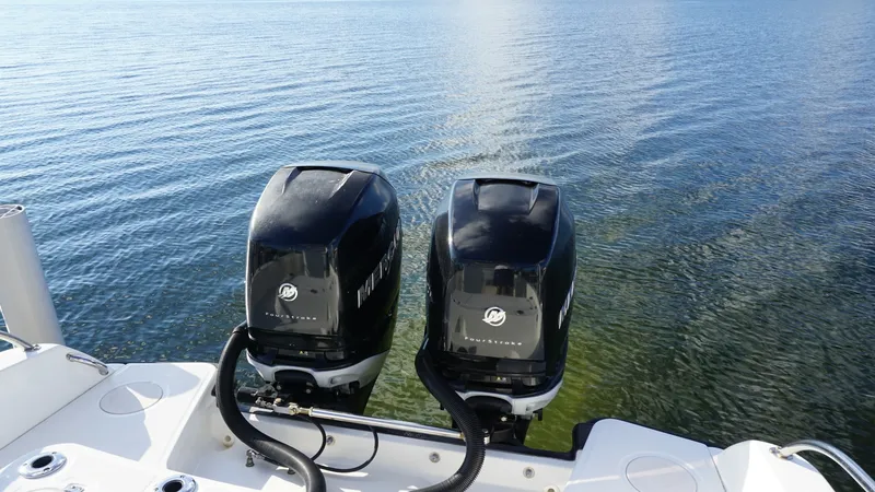 Slide: The Image of Twin Outboard Engines Aft View This image showcases the powerful twin outboard engines of the 2016 Boston Whaler 270 Dauntless. The sleek design and robust construction ensure top-notch performance and reliability on the water. Ideal for fishing or cruising, these engines promise a smo - 8087581