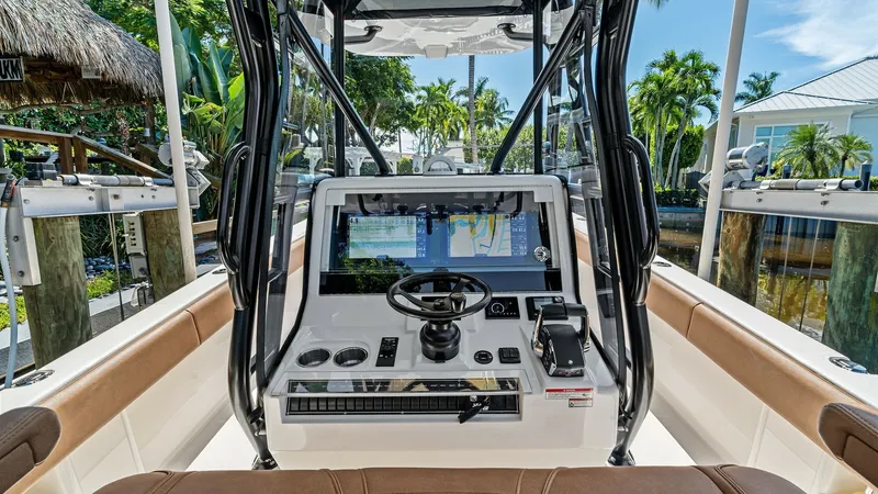Slide: The Image of Center Console Helm Station The 2024 SeaVee 340B features a sophisticated center console helm station equipped with advanced navigation technology. The ergonomic design includes a state-of-the-art display, intuitive controls, and a premium steering wheel, all framed by durable, slee - 8398179