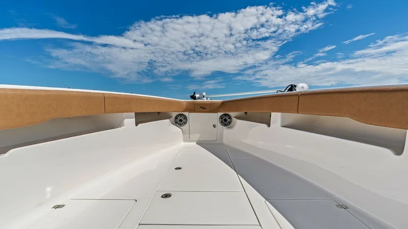 Slide: The Image of Spacious Bow Lounge Area The bow area of the 2024 SeaVee 340B offers a sleek and spacious design, perfect for relaxation and entertainment. The clean white finish provides a modern touch, while the integrated speakers ensure a high-quality audio experience. This area is ideal for - 8398202