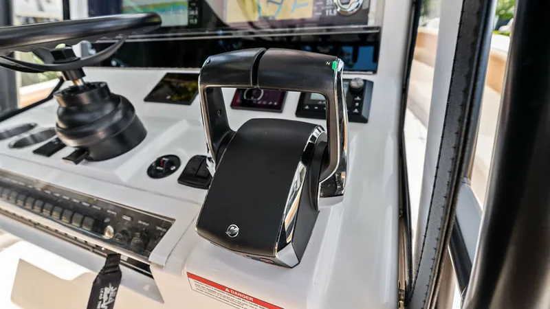 Slide: The Image of Helm Station with Throttle Controls The helm station of the 2024 SeaVee 340B features modern throttle controls for precise maneuverability. With an ergonomic layout and advanced digital displays, this area ensures an intuitive navigation experience. The sleek design and state-of-the-art con - 8398196