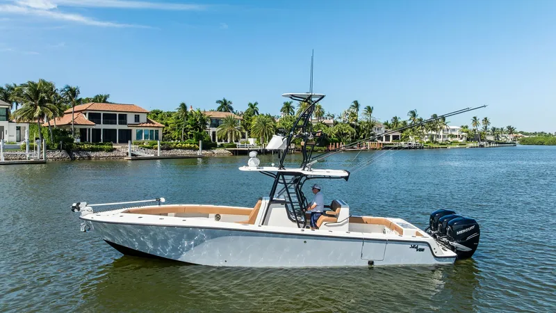 Slide: The Image of Side Profile of SeaVee 340B The 2024 SeaVee 340B is showcased in pristine waters, highlighting its sleek hull design and ample deck space. The side profile provides a clear view of the advanced tower with a dual helm station, ideal for sportfishing enthusiasts. Equipped with powerfu - 8398183
