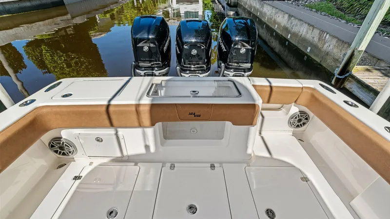 Slide: The Image of Aft Deck with Triple Outboards The aft deck of the 2024 SeaVee 340B is equipped with three powerful outboard engines, offering exceptional performance and speed. The spacious deck features a clean, non-skid surface with ample storage compartments, making it ideal for serious fishing or - 8398188