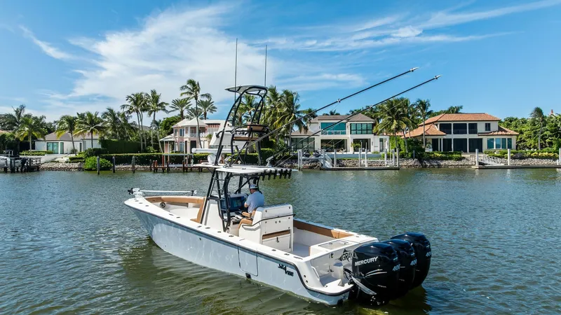 Slide: The Image of Aft View with Dual Outboards This image showcases the sleek aft design of the 2024 SeaVee 340B, featuring dual Mercury outboard engines for powerful performance. The open deck layout is optimized for fishing and leisure, offering ample space and a clean, functional setup. The scenic - 8398186