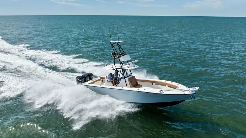 Slide: The Image of Aerial View of SeaVee 340B in Motion This dynamic aerial shot captures the SeaVee 340B slicing through the water with effortless grace. The vessel's sleek design and powerful outboard engines are highlighted as it creates an impressive wake. The spacious deck and advanced helm station are pe - 8398206