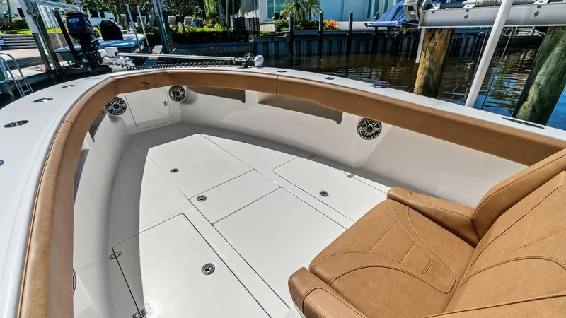 Slide: The Image of Spacious Bow Seating Area The bow of the 2024 SeaVee 340B, named 'Gray Area', features an expansive seating area with plush, tan cushions that provide comfort and style. The area is equipped with storage compartments beneath the seats, maximizing utility and functionality. The sle - 8398190