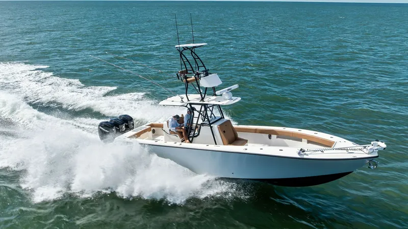 Slide: The Image of Aerial View of SeaVee 340B in Motion The 2024 SeaVee 340B, named Gray Area, elegantly cuts through the waves, showcasing its sleek hull and powerful outboard engines. The center console is equipped with a robust T-top and advanced navigation systems, ideal for serious offshore fishing. The s - 8398205