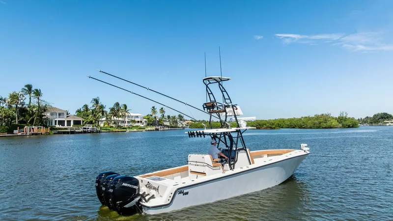 Slide: The Image of Aft View with Dual Outboards This image showcases the sleek aft section of the 2024 SeaVee 340B, highlighting its powerful dual outboard engines. The clean, open deck design is perfect for both fishing and leisure, with ample space for movement and gear. The elevated tower provides e - 8398185