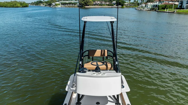Slide: The Image of Flybridge Helm Station with Tower The 2024 SeaVee 340B features a well-equipped flybridge helm station, offering an elevated view for superior navigation. The compact tower includes a sleek steering console and cushioned seating, designed for comfort and functionality. Its strategic posit - 8398182