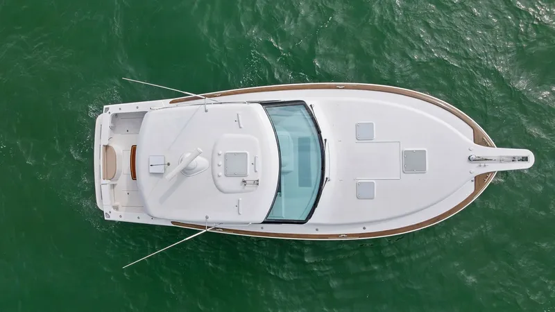Slide: The Image of Aerial View of Deck and Bow This image showcases the pristine deck and sleek bow of the 2017 Hatteras GT45X. The spacious layout features a streamlined design with two hatches for easy access and ventilation. The vessel's elegant lines and advanced navigational equipment enhance bot - 8439519