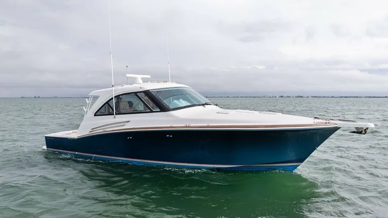 The Image of Starboard Bow View This image showcases the sleek starboard bow of the 2017 Hatteras GT45X, SEA'N ME TOO. The vessel's elegant blue hull contrasts beautifully against the water, highlighting its graceful lines and robust construction. The hardtop and aerodynamic design emph - 8439513
