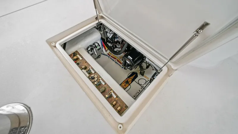 Slide: The Image of Engine Room Access Hatch This image showcases the engine room access hatch on the Hatteras GT45X. The hatch provides easy entry to the well-organized mechanical space below deck. Notable features include robust stainless steel hinges and a clean, spacious design, offering efficie - 8439558