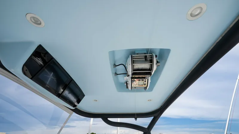 Slide: The Image of Enclosed Bridge Ceiling with Outrigger The image showcases the sleek ceiling of the Viking 92 Enclosed Bridge, featuring an integrated outrigger control system. The modern design includes recessed lighting, enhancing the space's functionality and aesthetic. This setup ensures efficient managem - 8439598