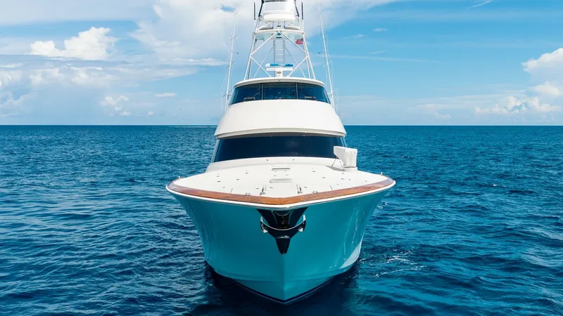 Slide: The Image of Bow View with Enclosed Bridge This striking bow view showcases the sleek lines and robust construction of the Viking 92 Enclosed Bridge. The expansive foredeck is accentuated by elegant teak finishes, offering a blend of luxury and functionality. The vessel's towering profile and encl - 8439648