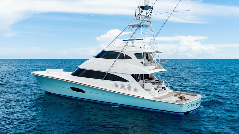 Slide: The Image of Portside View of Viking 92 Enclosed Bridge This image showcases the sleek and powerful profile of the 2017 Viking 92 Enclosed Bridge, named Double Barrel. The portside view highlights the vessel's elegant lines and expansive deck space, perfect for both relaxation and sportfishing. The flybridge i - 8439646