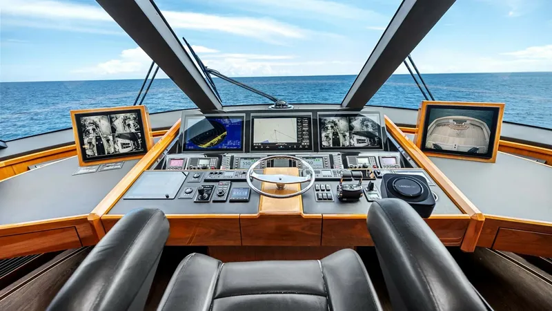 Slide: The Image of Enclosed Bridge Helm Station The helm station of the 2017 Viking 92 Enclosed Bridge offers a commanding view with state-of-the-art navigation systems. Featuring a sleek, ergonomic design, the helm is equipped with multiple displays for comprehensive control and monitoring. Luxurious - 8439571