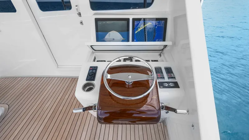 Slide: The Image of Helm Station with Navigation Displays The helm station of the 2017 Viking 92 Enclosed Bridge features a sleek, polished wood steering wheel and state-of-the-art navigation displays. The ergonomic layout ensures ease of control, while the large screens provide critical navigation and system in - 8439593