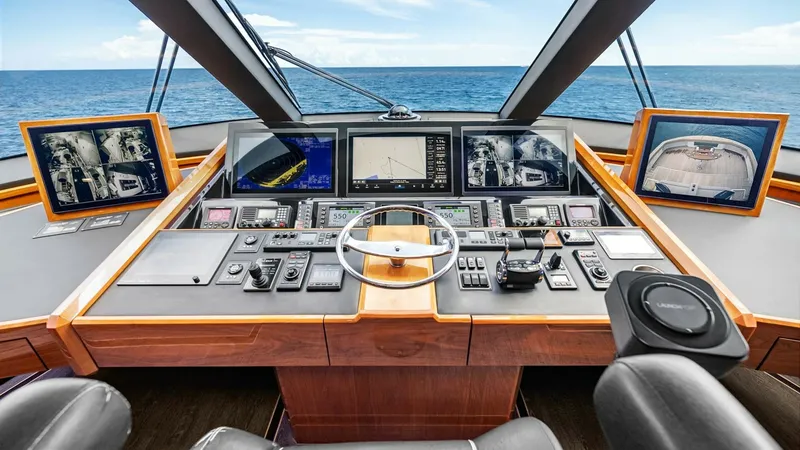 Slide: The Image of Enclosed Bridge Helm Station The helm station of the 2017 Viking 92 Enclosed Bridge features state-of-the-art navigation and control systems. With multiple large display screens, advanced instrumentation, and ergonomic seating, it ensures a commanding view and ease of operation. The - 8439587