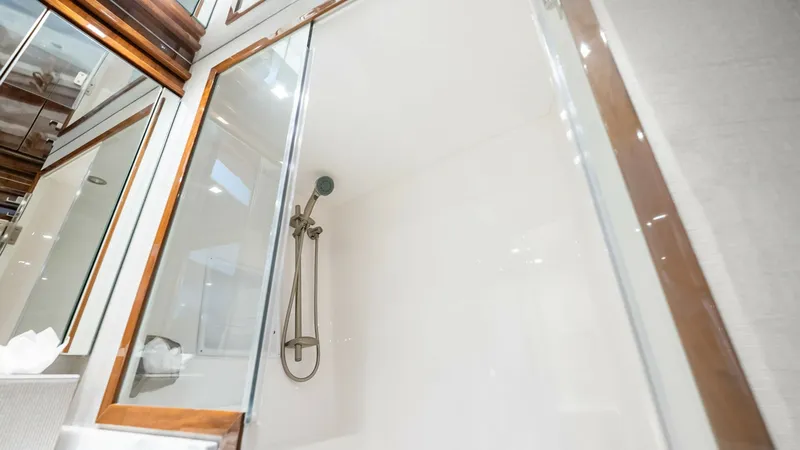 Slide: The Image of Luxurious Enclosed Shower This image showcases the elegant enclosed shower aboard the 2017 Viking 92 Enclosed Bridge. Featuring sleek glass doors and modern fixtures, the shower provides a sophisticated and refreshing experience. The high-quality finishes and ample lighting enhanc - 8439621