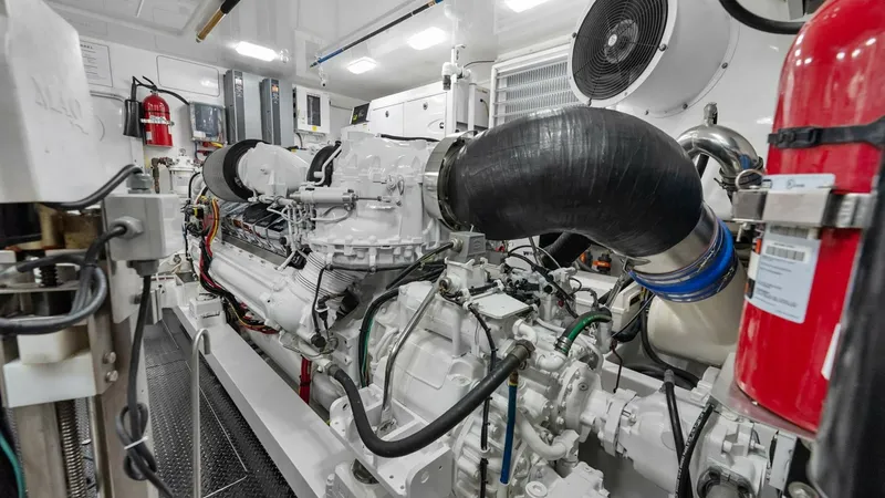 Slide: The Image of Engine Room with Twin Engines The engine room of the 2017 Viking 92 Enclosed Bridge showcases twin powerful engines, providing exceptional performance and reliability. The space is meticulously organized, featuring advanced engineering and robust construction for optimal efficiency. H - 8439634