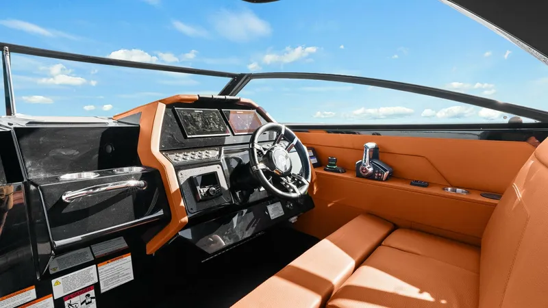 Slide: The Image of Helm Station with Advanced Controls The helm station of the 2022 Cruisers Yachts 34 GLS features a sleek, modern design with state-of-the-art navigation controls. The dashboard is equipped with advanced touch-screen displays and precision steering, ensuring effortless maneuverability. Luxur - 8398516