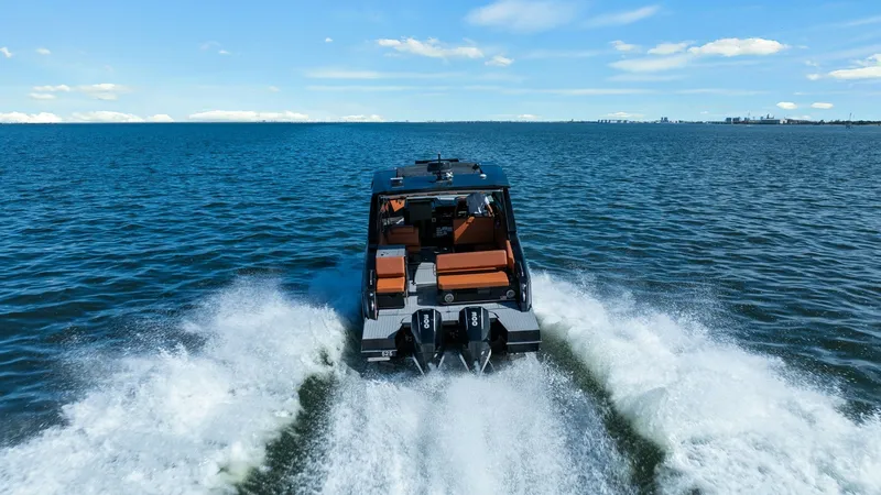 Slide: The Image of Aft View with Dual Engines This image captures the sleek aft view of the 2022 Cruisers Yachts 34 GLS, showcasing its powerful dual outboard engines cutting through the water. The spacious cockpit area is highlighted by luxurious seating, perfect for socializing and relaxation. The - 8398547