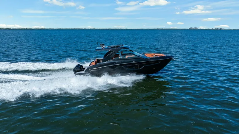 Slide: The Image of Cruisers Yachts 34 GLS in Action The 2022 Cruisers Yachts 34 GLS glides effortlessly across open waters, showcasing its sleek and modern design. Its streamlined hull and powerful outboard engines provide an exhilarating ride, while the spacious deck offers ample seating for relaxation. P - 8398550