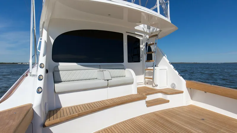 Slide: The Image of Spacious Aft Deck with Seating The aft deck of the 2024 Viking Nomad 54 Convertible offers a blend of luxury and functionality with its sleek, cushioned seating area. The teak decking adds a touch of elegance, providing a perfect setting for relaxation or entertaining guests. The thoug - 8439803