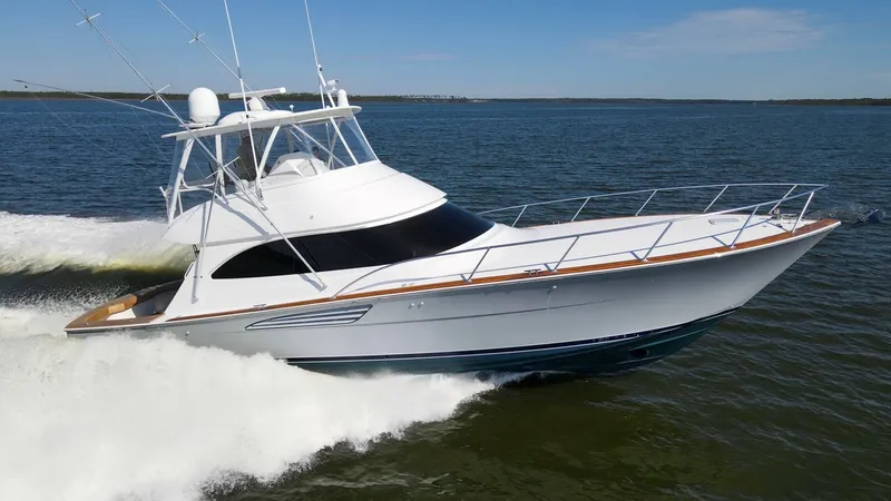 Slide: The Image of Side View of Viking 54 Convertible The 2024 Viking 54 Convertible, Nomad, showcases its sleek profile and robust build as it cuts through the water. The elegant curvature of the bow and the expansive flybridge with its commanding view highlight the vessel's modern design. Stainless steel r - 8439836