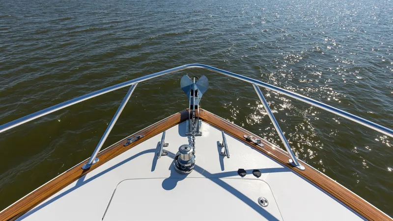 Slide: The Image of Bow with Anchor System The forward view of the 2024 Viking 54 Convertible showcases a sleek bow equipped with a robust anchor system. The stainless steel hardware and polished teak accents highlight the luxury craftsmanship typical of Viking vessels. Expansive water views empha - 8439814