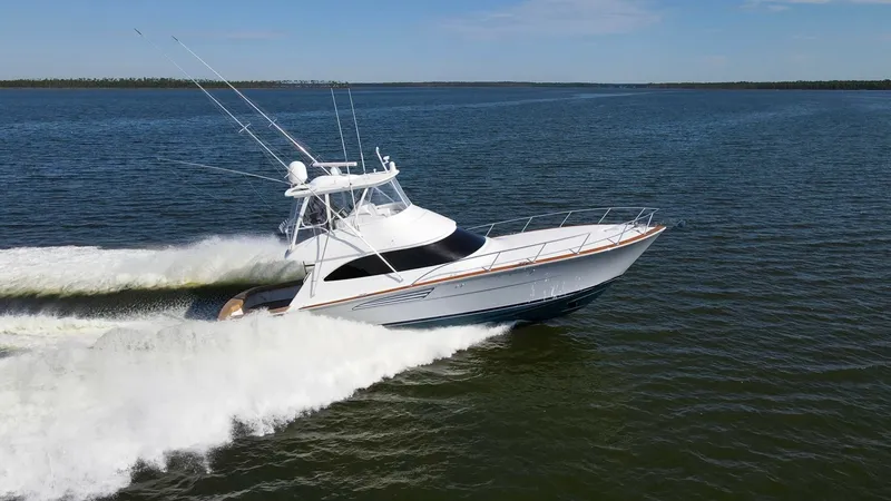 Slide: The Image of Dynamic Bow View in Motion The 2024 Viking 54 Convertible, Nomad, glides effortlessly across the water, showcasing its sleek and powerful hull design. The bow is elegantly contoured with a robust stainless steel rail, enhancing both safety and aesthetics. Its aerodynamic profile an - 8439822