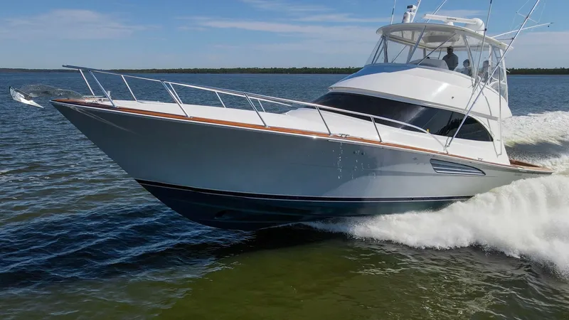 Slide: The Image of Dynamic Bow View in Motion This image showcases the sleek bow of the 2024 Viking 54 Convertible, 'Nomad', slicing through the water with impressive agility. The vessel's sharp lines and polished finish highlight its superior craftsmanship and performance capabilities. The expansive - 8439829